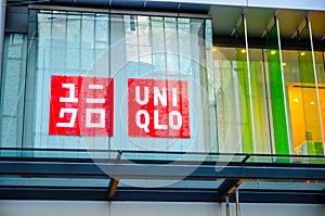 Uniqlo Japanese casual wear retailer logo at a shop front glass window, Pitt St. Mall, Sydney CBD.